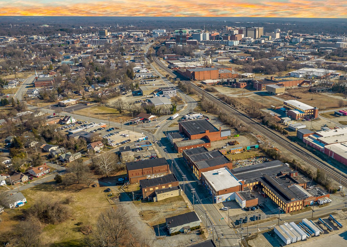 Aerial view looking toward downtown High Point, with Melrose Mill in the foreground beside the rail line