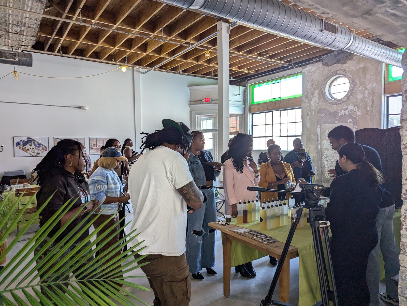 Participants gathered around a table during a hands-on workshop in the mill