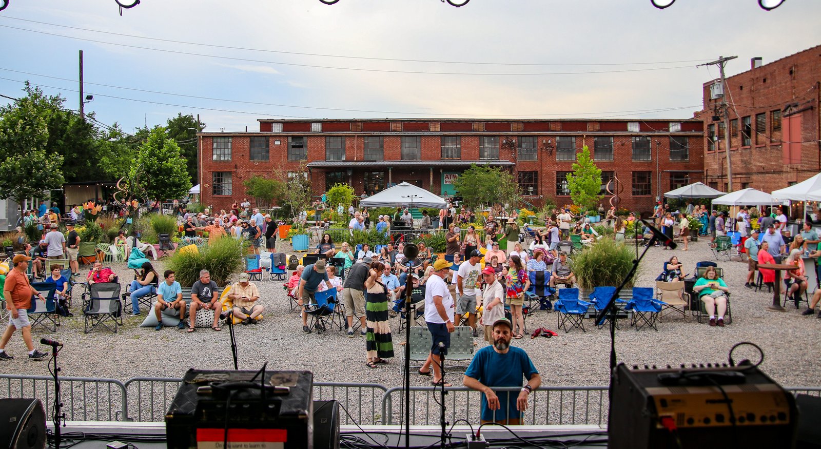 Crowd gathered in the mill courtyard for an evening concert