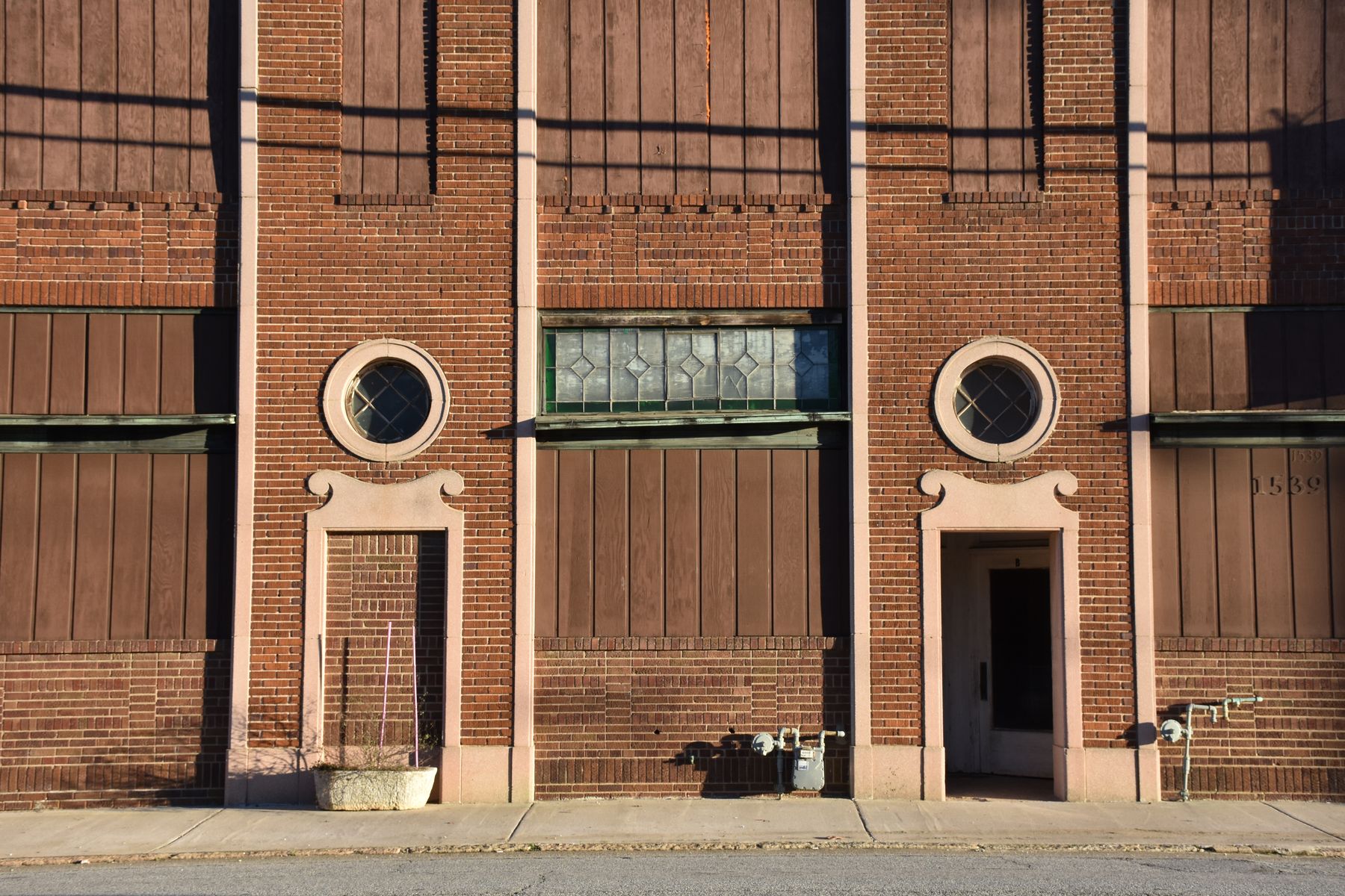 1928 facade with round windows and leaded-glass transom