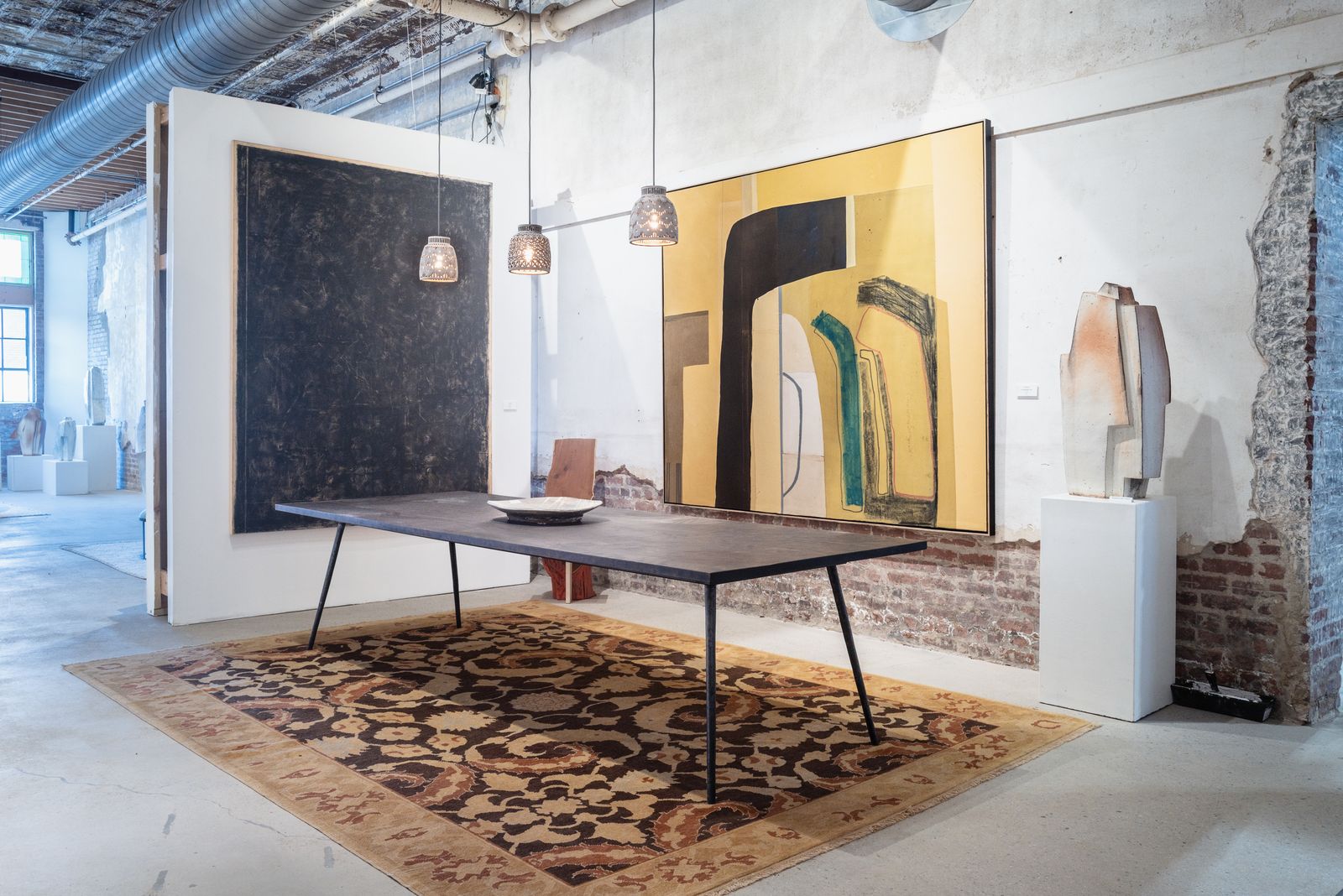Dining vignette beneath large paintings