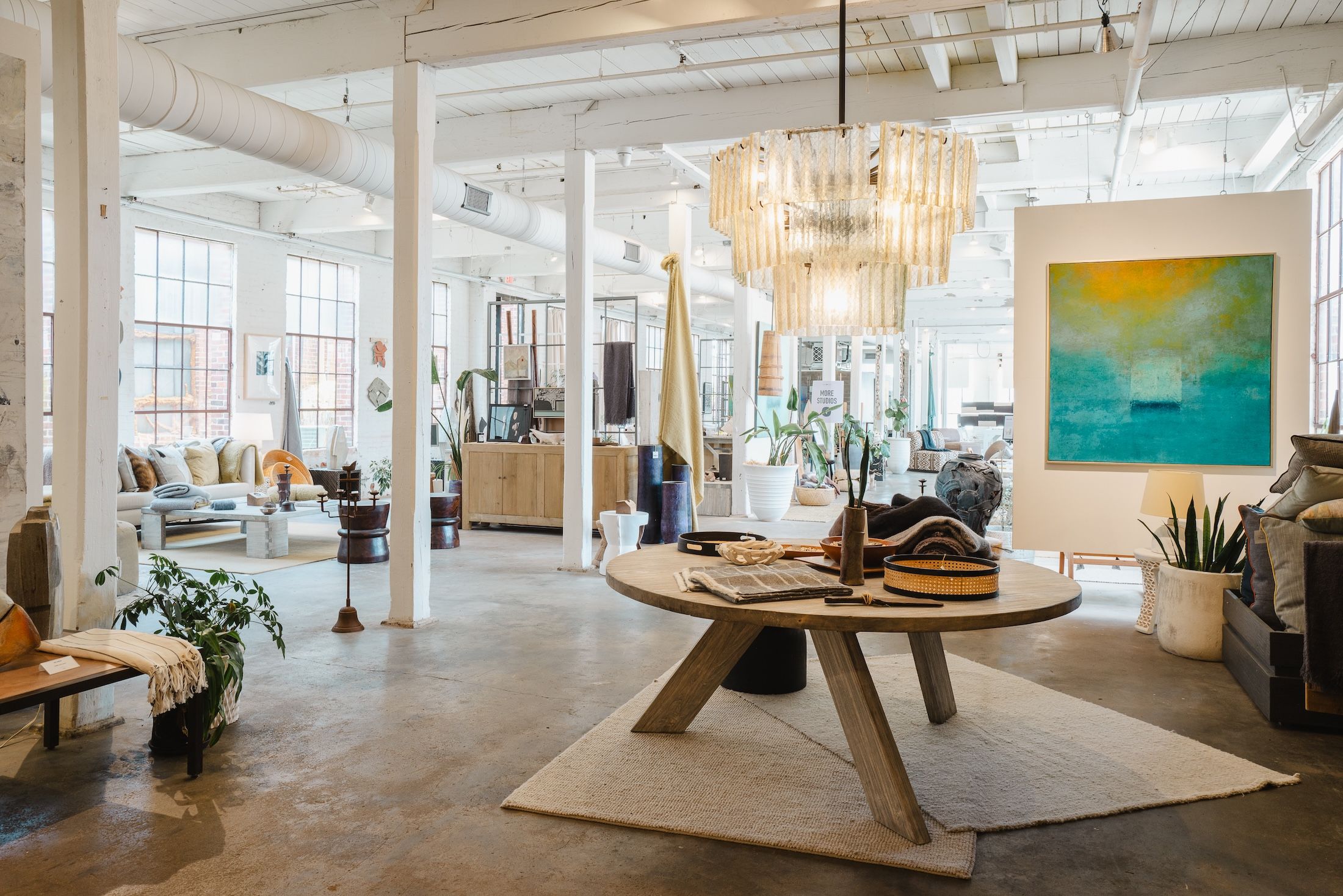 3B trade showroom, with white timber columns and a tiered chandelier