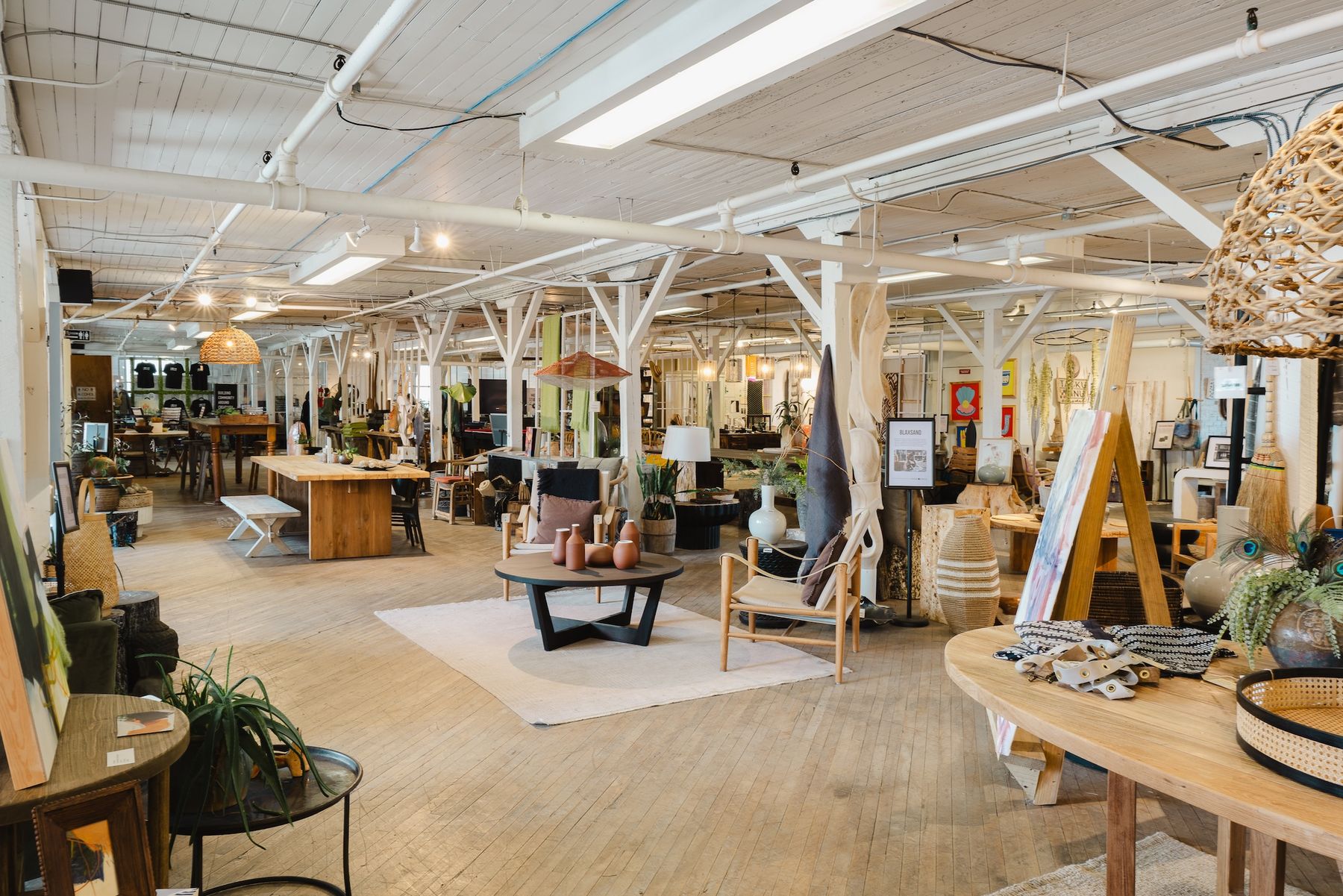 Second-floor showrooms under timber trusses, set up for Market